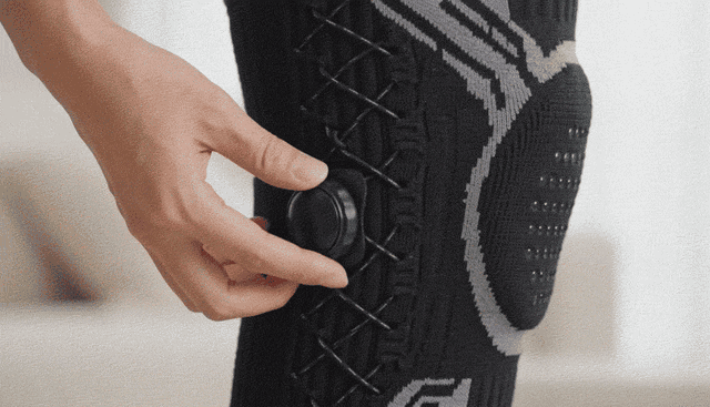 Turning the dial to tighten the knee brace